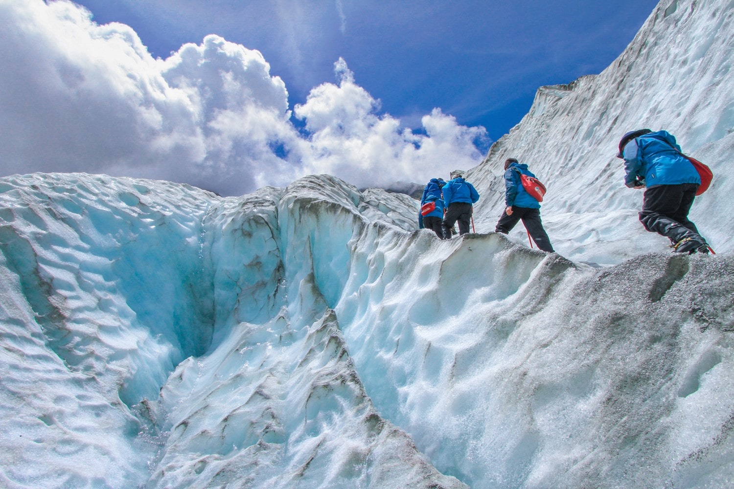 a group of hikes walk through a is mountain